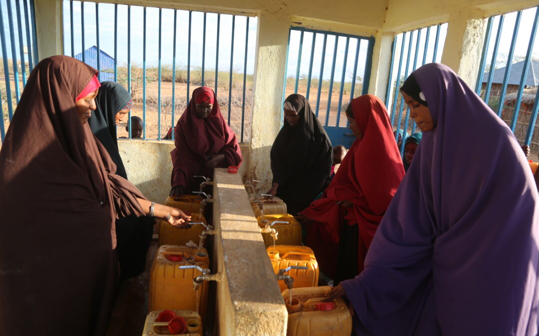 Bringing water near to  Mama Quresha Mohamed in Suriyo Village